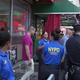 NYPD officers escort salon workers out of the salon following protests